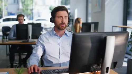 Customer Service Consultant Helping Client in Headset in Coworking Space Closeup
