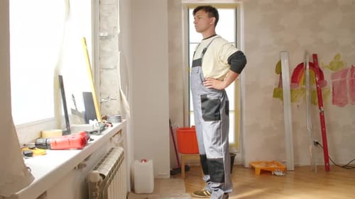 Worker Standing in Room Being Remodeled