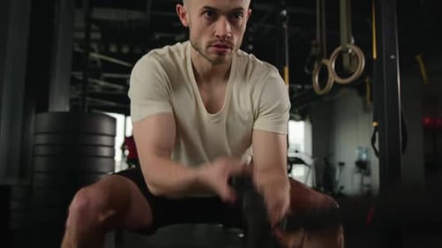 Man Doing Battle Rope Workout in Gym