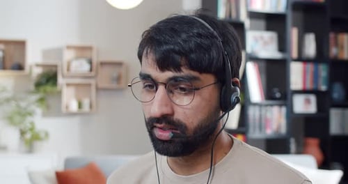 Close Up of Arabian Young Man in Headset Talking and Videochatting at Home Call Center Worker at