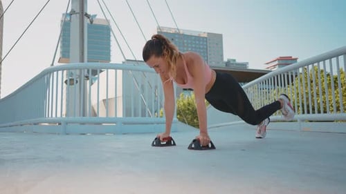 Fit Woman Doing Pushups on Bridge