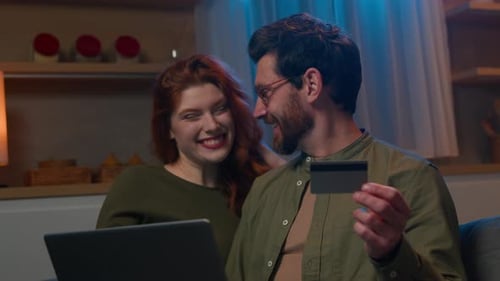 Couple Shopping Online at Home With Credit Card