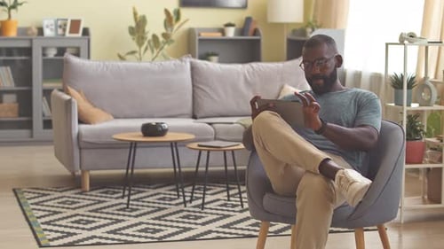 Man Using Tablet in Living Room