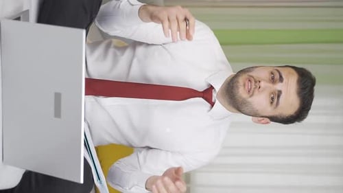 Vertical Video of The businessman who is bored and overwhelmed by the work is unhappy.