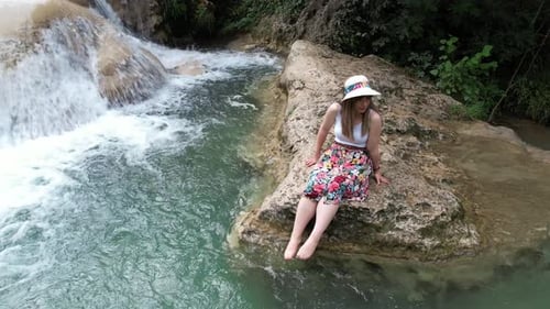 Aerial View Of Woman Resting In Waterfall