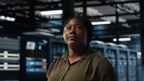 Portrait of Cheerful Data Center Engineer Conducting Security Audits