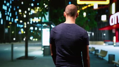 Man Walking Alone in City at Night