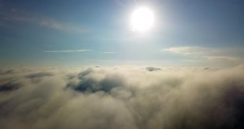 4K of floating in the clouds. With the clouds starting at eye level. Then slowly transitions into th