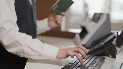Hotel Receptionist Entering Passport Data