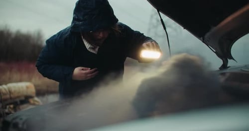 Frustrated Woman Inspecting Smoke Coming out of Broken Car Engine. Vehicle Breakdown Road Side Accid