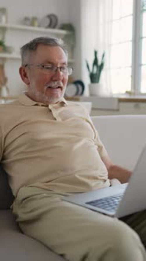 Senior Man on Laptop Video Call at Home