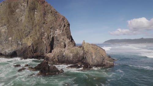Close fly by of Haystack Rock at Cannon Beach