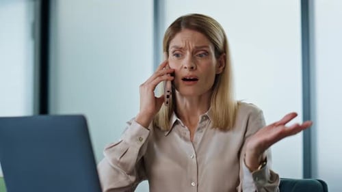 Annoyed Business Woman Calling Phone at Work Desk Closeup. Nervous Office Manager