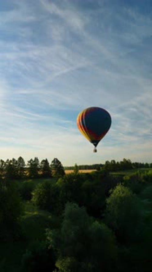Hot Air Balloon Floating over Rural Landscape