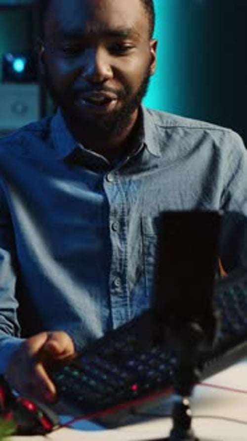 Man Vlogging About Gaming Keyboard and Headphones