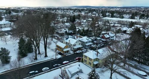 Quaint cute homes in small America town in winter snow. Aerial establishing shot in Lititz Lancaster