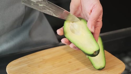 Cutting Fresh Avocado in Half with Knife