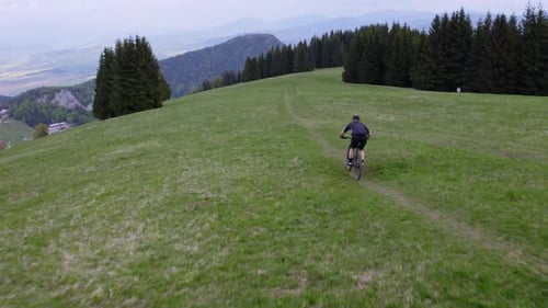 Mountain bike rider cycling through the beautiful and lush rural countryside of Liptov, Slovakia. Ae