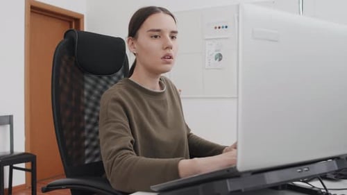 Young Woman Suffering Headache At Work