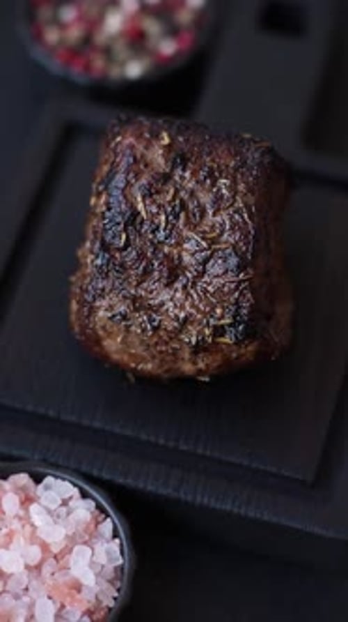 Close-Up of Seasoned Meat Cut on Wooden Board