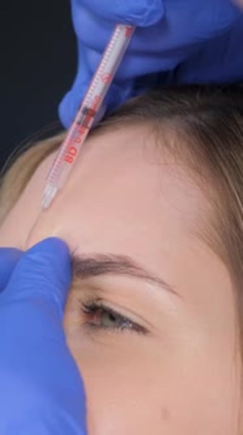 Woman Receiving Forehead Injection in Close Up