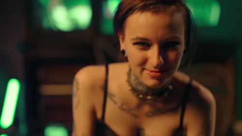 Freaky Woman with Tattoos on Body and Piercing on Face in Studio Portrait Smiling Lady in