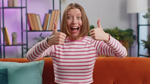 Young Adult Woman Gives Thumbs Up Indoors