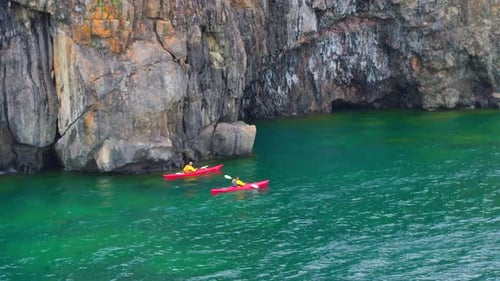 Kayaking Through Rocky Water Cliffs Aerial Drone 3 People