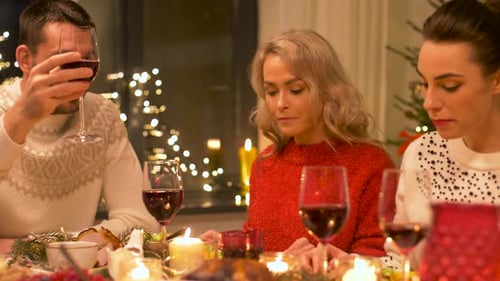 Friends Celebrating Holiday Season with Wine at Dinner