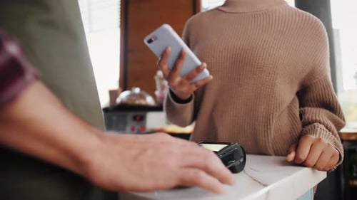 Customer Paying with NFC Technology By Smart Watch Contactless on Terminal in Modern Cafe Barman