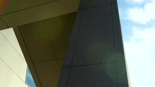 Underneath view of modern architecture with a clear sky.