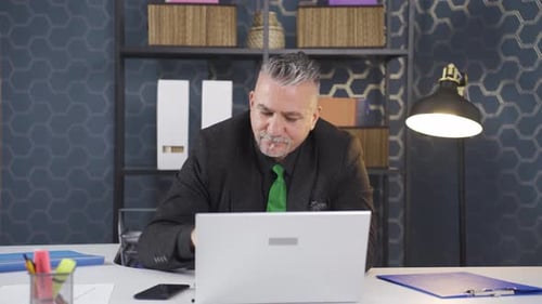 Professional Man Works at Desk in Modern Office