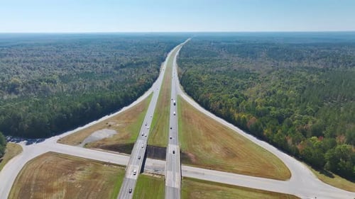 Aerial View of Freeway Overpass Junction with Fast Moving Traffic Cars and Trucks in American Rural