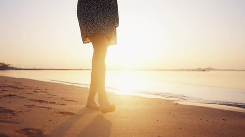 Barefooted Legs of Woman Tourist Barefooted Feet Walking on Sandy Ocean Beach Leaving Footprints in