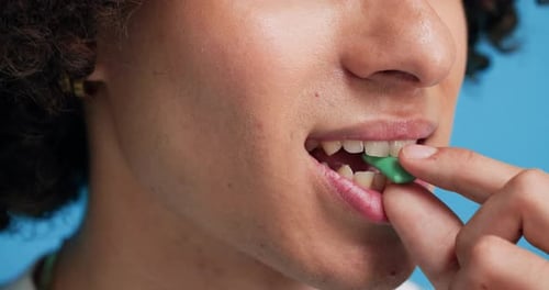Chewing gum, closeup and man in studio for fresh breath, teeth whitening and smell for odor