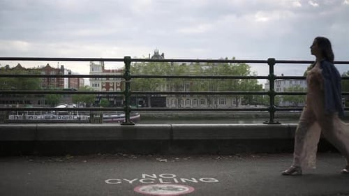 Fashionable latina tourist with black wavy hair and a jean jacket walking and spinning in London wit