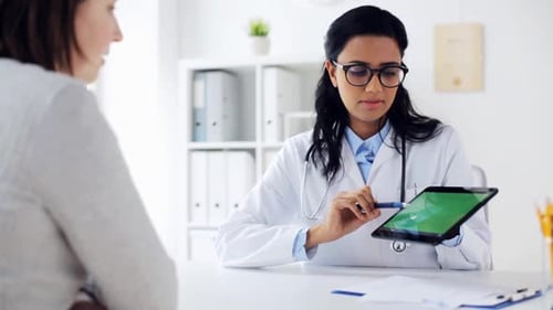 Doctor Consults with Patient Using Digital Tablet