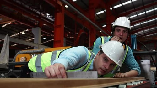 Two specialists inspect commercial, Wear safety uniform and White helmet work