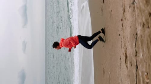 Woman Exercising on Beach Doing Push-Ups
