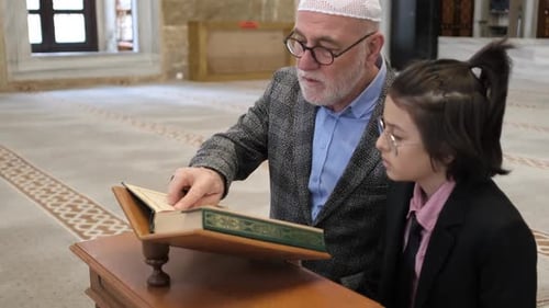 Man Teaching Child From Book Inside Mosque