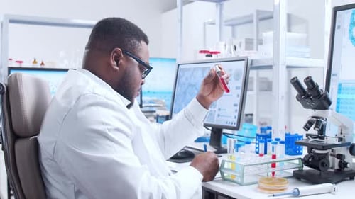 Researcher Analyzing Test Tubes in Bright Modern Lab