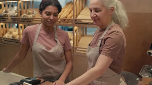 Female Bakery Workers Using Cash Register
