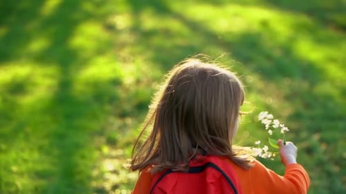 Child Runs and Laughs in Summer Park Happy Girl with School Backpack Outdoors