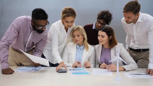 Green Renewable Energy, Teamwork, Corporate And People Concept - Business Team With Papers And Wi...