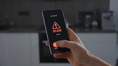 Incoming Scam Call on Smartphone in Hand at Home