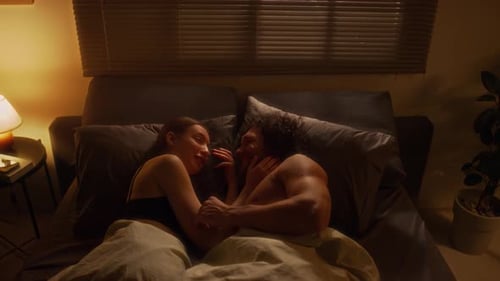 Affectionate Couple in Bed Together