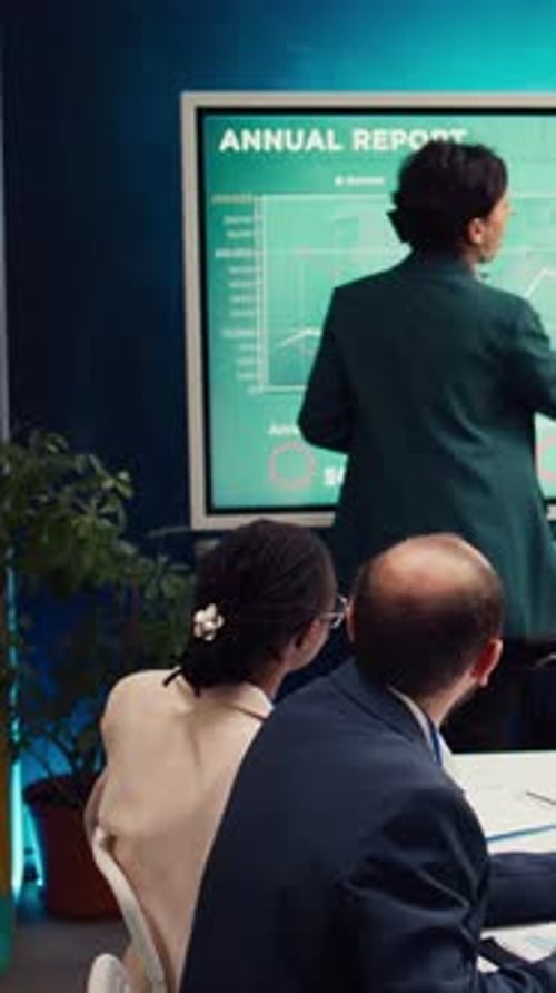 Office Administrator Presenting Data Reports and Funding on Interactive Board