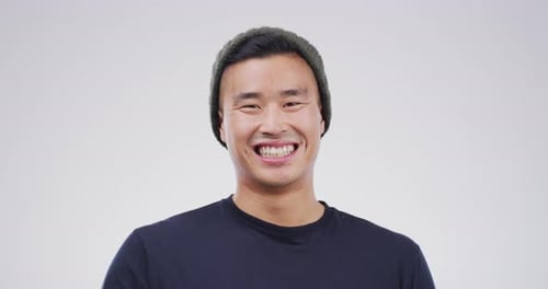 Smiling Young Man Gives Thumbs Up Sign