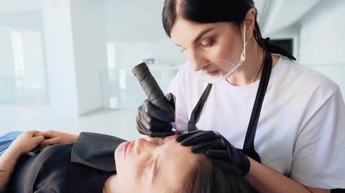 Cosmetologist Performs Microblading Procedure on Woman