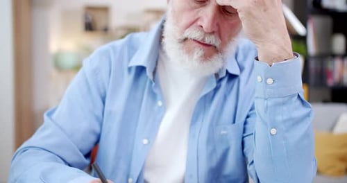 Caucasian Old Male Sitting at Desk in Cozy Living Room and Writing in Notebook His Thoughts Close Up